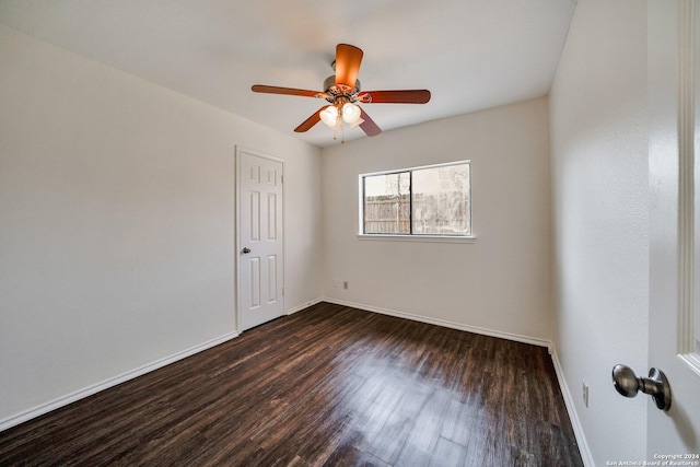 unfurnished room with dark hardwood / wood-style flooring and ceiling fan