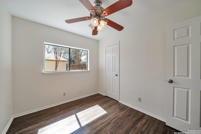 unfurnished bedroom featuring dark hardwood / wood-style flooring, a closet, and ceiling fan