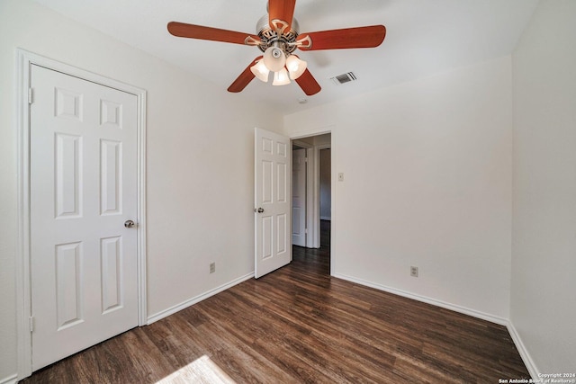 unfurnished bedroom with dark wood-type flooring and ceiling fan