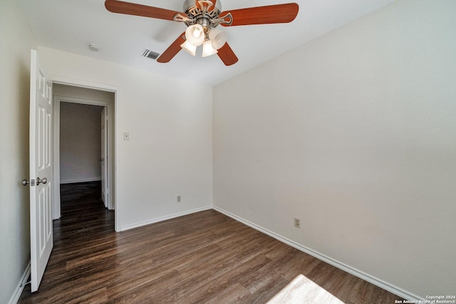 spare room with ceiling fan and dark hardwood / wood-style floors