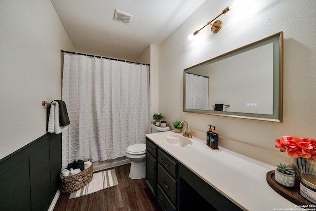 bathroom featuring vanity, wood-type flooring, and toilet