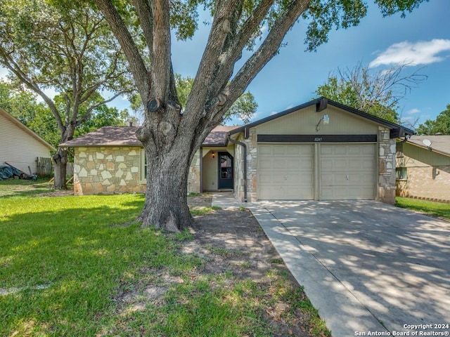 ranch-style home with a garage and a front yard