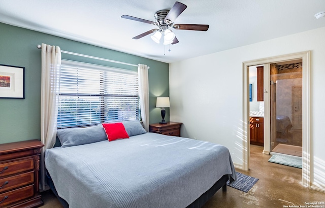 bedroom with concrete flooring, ceiling fan, and ensuite bath