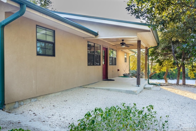 exterior space with ceiling fan