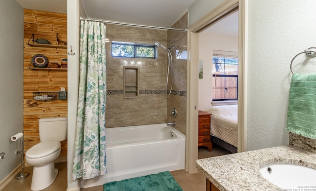 full bathroom featuring shower / tub combo with curtain, a healthy amount of sunlight, toilet, and vanity