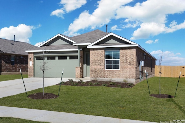 view of front of property featuring a garage and a front lawn