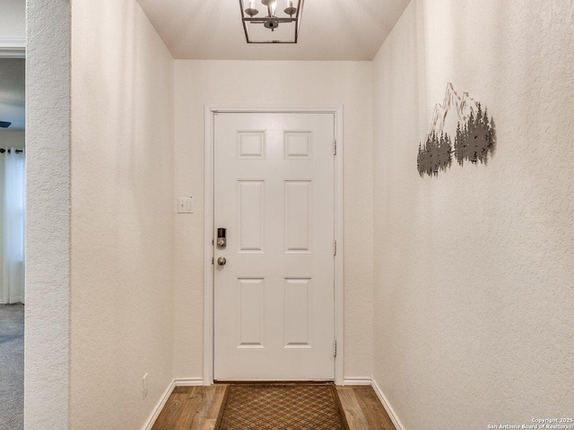 doorway with wood-type flooring