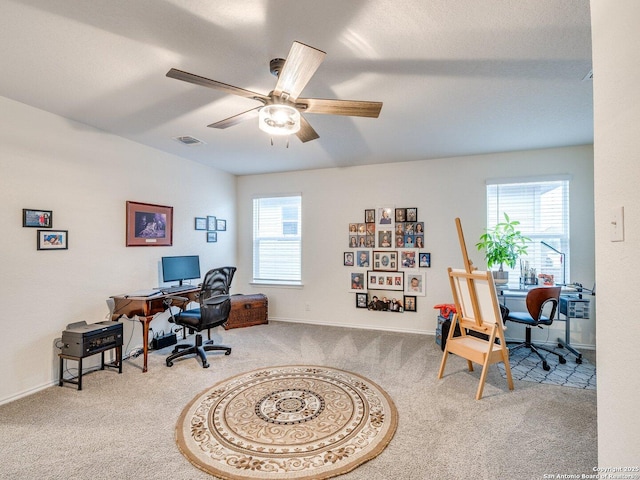 office space with ceiling fan, a healthy amount of sunlight, and carpet