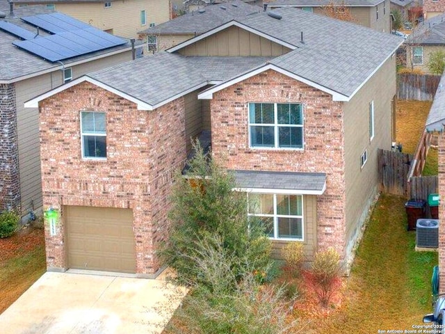 view of front of home featuring a garage and central AC unit