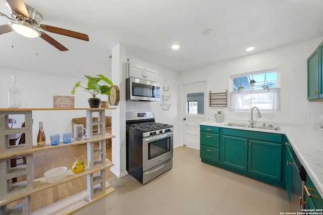 kitchen featuring stainless steel appliances, sink, ceiling fan, and green cabinetry