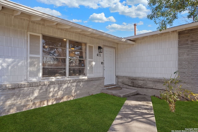 property entrance with a yard