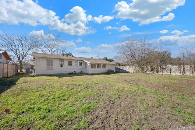 rear view of house with a yard and central air condition unit