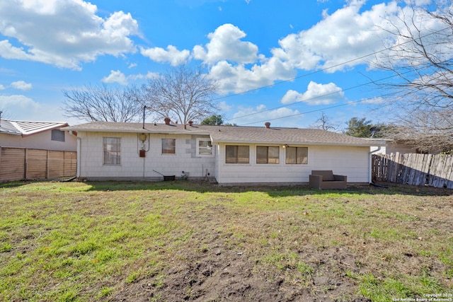 rear view of property with a yard