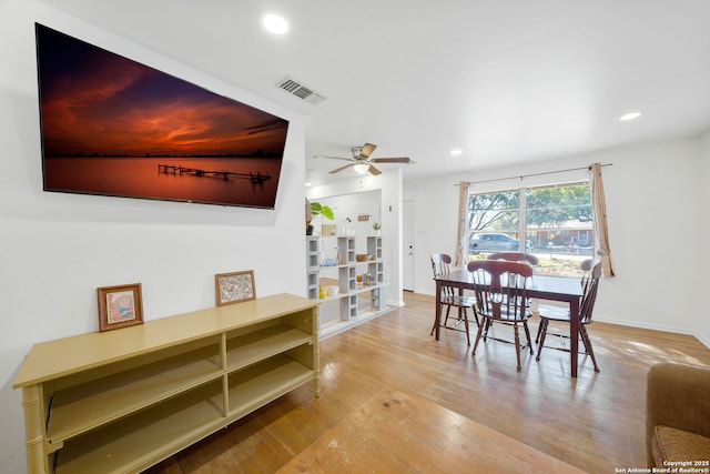 dining room with ceiling fan and light hardwood / wood-style flooring