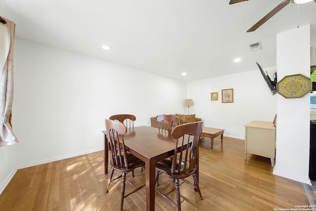 dining space with ceiling fan and light hardwood / wood-style floors