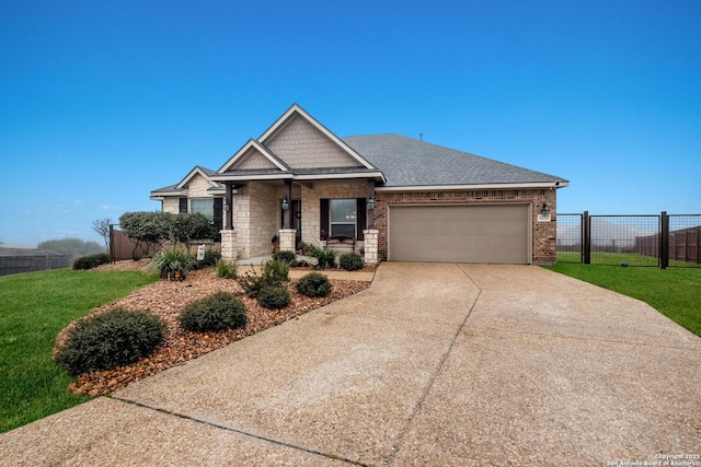 view of front of property featuring a garage and a front lawn