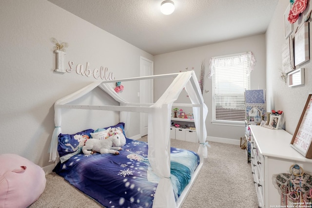 bedroom featuring light carpet and a textured ceiling