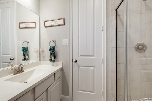 bathroom with vanity and tiled shower