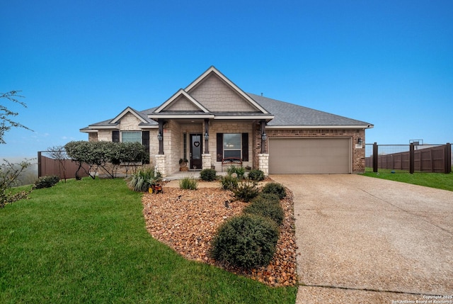 view of front facade featuring a garage, a front yard, and covered porch