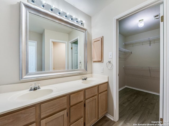 bathroom with vanity and wood-type flooring