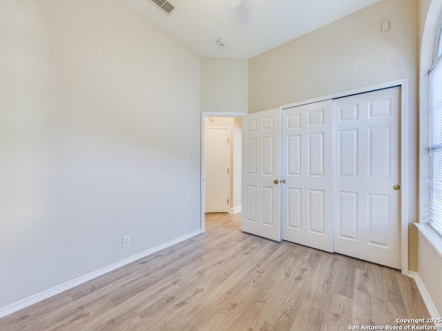 unfurnished bedroom featuring a closet and light wood-type flooring