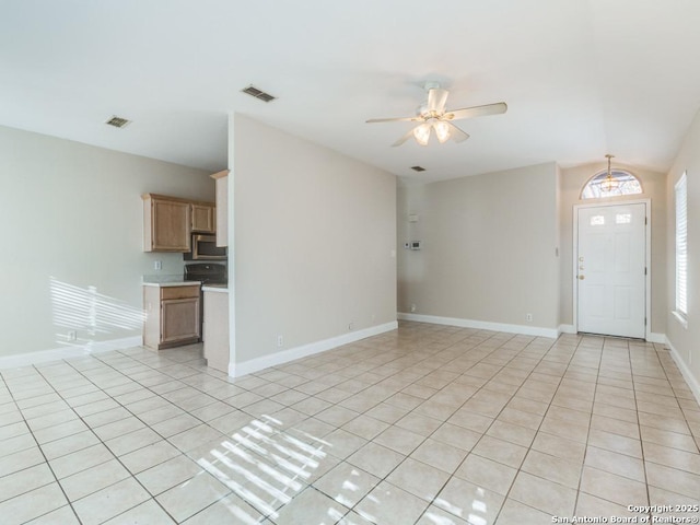 interior space with light tile patterned flooring, lofted ceiling, and ceiling fan