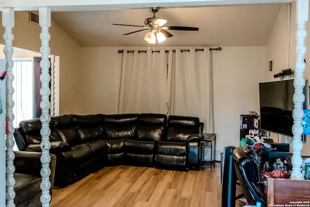 living room featuring wood-type flooring, vaulted ceiling, and ceiling fan