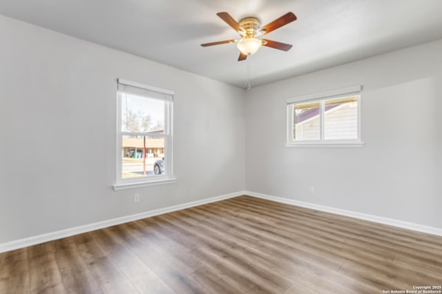 unfurnished room with hardwood / wood-style floors and ceiling fan