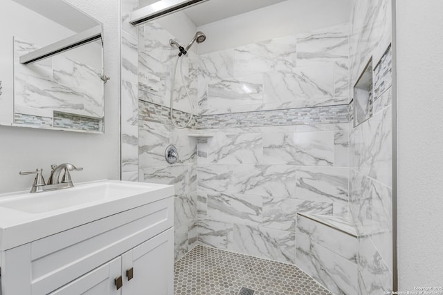 bathroom featuring vanity and tiled shower