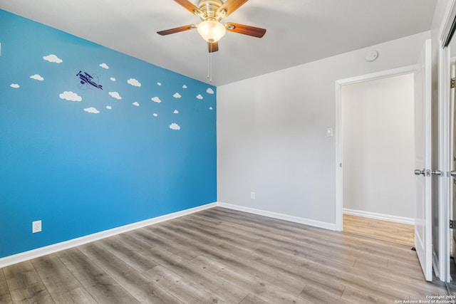 unfurnished room featuring ceiling fan and light hardwood / wood-style floors