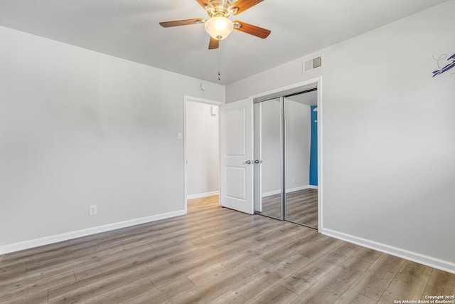 unfurnished bedroom with a closet, ceiling fan, and light wood-type flooring