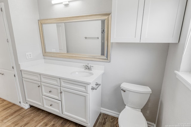 bathroom with vanity, toilet, and wood-type flooring