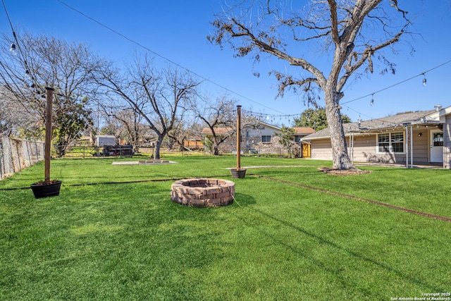 view of yard with a fire pit