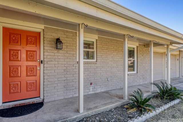 property entrance featuring a garage and covered porch