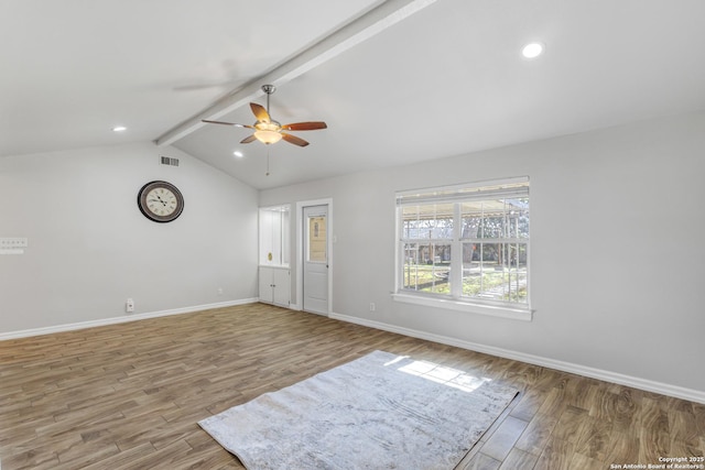 unfurnished room with ceiling fan, hardwood / wood-style floors, and vaulted ceiling with beams