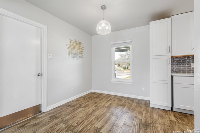 unfurnished dining area with light hardwood / wood-style floors