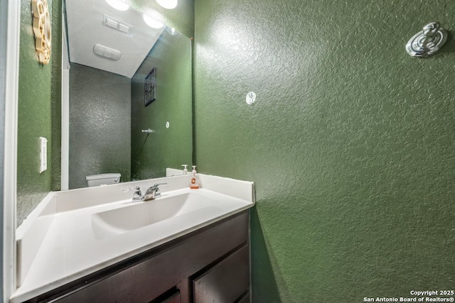 bathroom featuring vanity and toilet