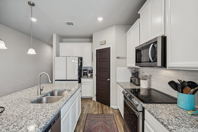 1274 Lennea, New Braunfels, TX 78130 - kitchen with light stone countertops, white cabinetry, appliances with stainless steel finishes, and sink