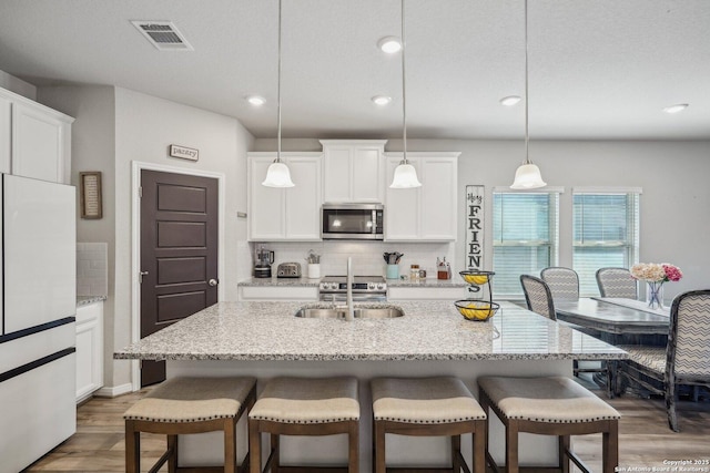 1274 Lennea, New Braunfels, TX 78130 - kitchen featuring pendant lighting, white cabinetry, and a center island with sink
