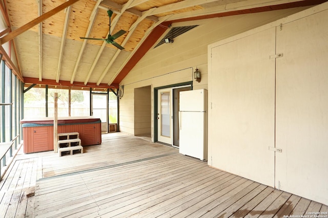 unfurnished sunroom featuring ceiling fan and lofted ceiling