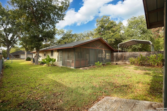 view of yard featuring a sunroom and a carport