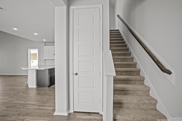 10257 Bartenheim Dr, Schertz, TX 78154 - staircase with wood finished floors, recessed lighting, and baseboards