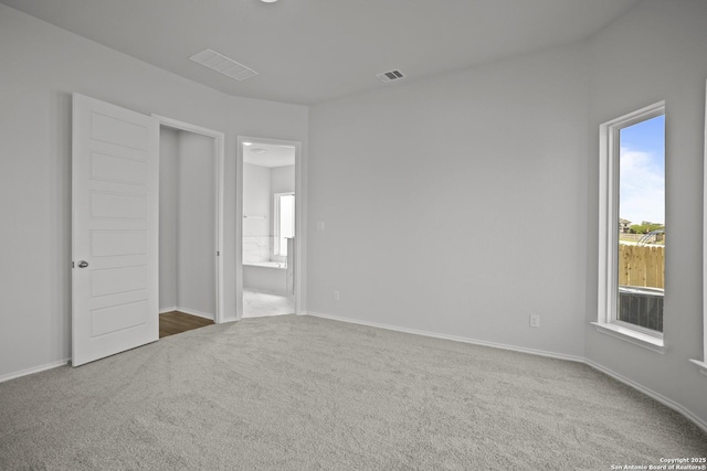 10257 Bartenheim Dr, Schertz, TX 78154 - unfurnished bedroom featuring carpet flooring, multiple windows, ensuite bath, and baseboards