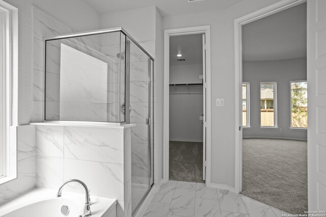 10257 Bartenheim Dr, Schertz, TX 78154 - bathroom featuring a marble finish shower, a bath, marble finish flooring, and baseboards