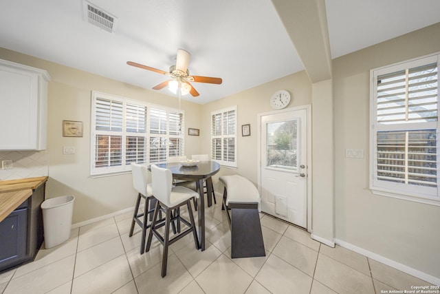 dining space featuring light tile patterned flooring, ceiling fan, and a healthy amount of sunlight