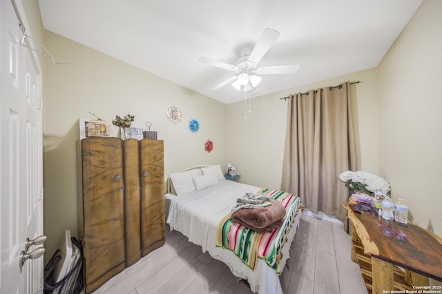 bedroom featuring light hardwood / wood-style floors and ceiling fan