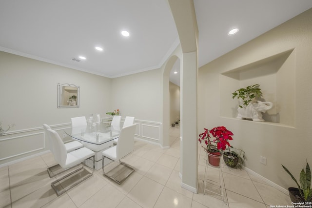 dining area featuring crown molding and light tile patterned floors