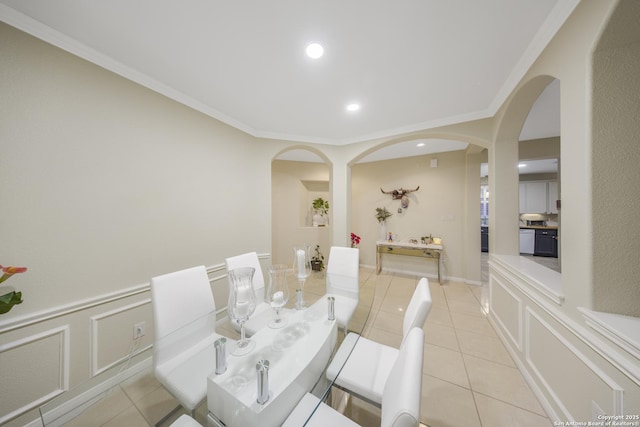 dining space featuring crown molding and light tile patterned floors