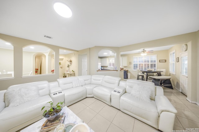 living room with light tile patterned floors and ceiling fan