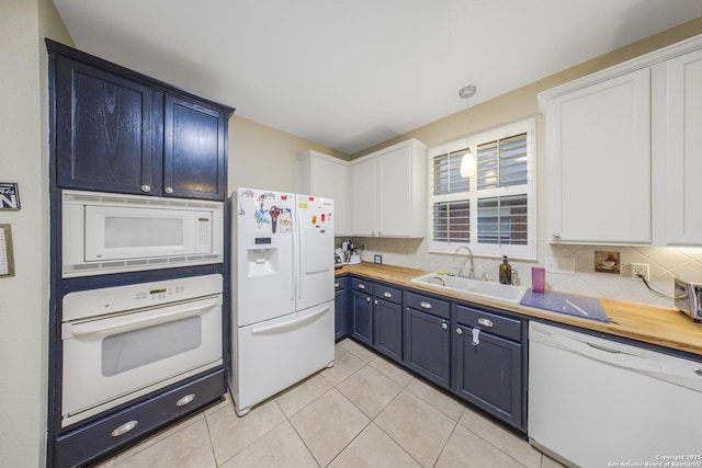 kitchen with white cabinetry, white appliances, sink, and hanging light fixtures